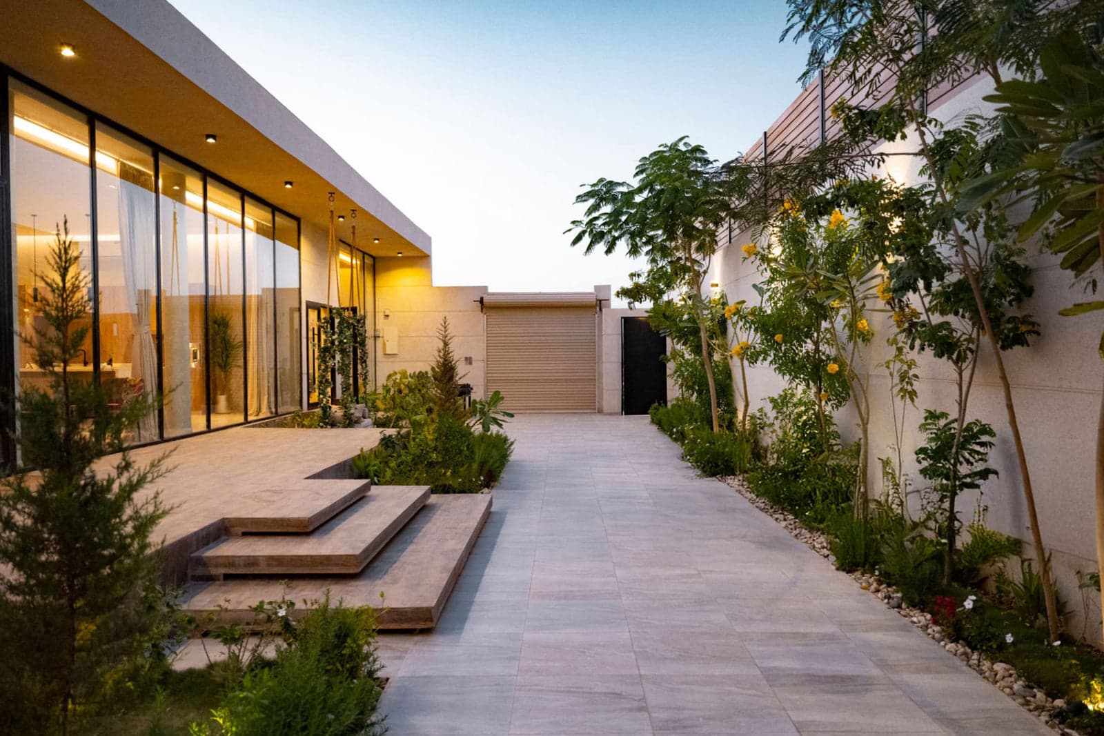 Architectural garden and facade lighting installed at a modern Sunshine Coast home at dusk